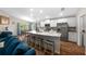 Modern kitchen featuring a large island, stainless steel appliances, and seamless integration with the living area at 11330 Sw 61St Cir, Ocala, FL 34476