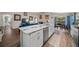 Open-concept kitchen featuring a large island with stainless steel dishwasher and marble countertops at 11330 Sw 61St Cir, Ocala, FL 34476