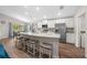Bright kitchen featuring a large island, stainless steel appliances, and an adjacent dining area at 11330 Sw 61St Cir, Ocala, FL 34476