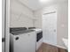 Modern laundry room with a full-size washer and dryer, complemented by storage shelves at 11330 Sw 61St Cir, Ocala, FL 34476