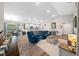 Open-concept living room featuring modern furnishings and abundant natural light with luxury vinyl plank flooring at 11330 Sw 61St Cir, Ocala, FL 34476