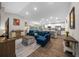 Open-concept living room featuring plush seating, contemporary decor, and seamless flow to other living areas at 11330 Sw 61St Cir, Ocala, FL 34476
