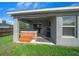 Back patio area with a built-in hot tub and a grill, perfect for outdoor entertaining at 11330 Sw 61St Cir, Ocala, FL 34476