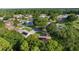 Drone shot of the homes, solar panels, mature trees, and other homes at 11598 Sw 74Th Ct, Ocala, FL 34476