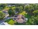 Aerial view showcasing the home's manicured lawn, solar panels, and landscaped surroundings at 11598 Sw 74Th Ct, Ocala, FL 34476