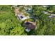 Overhead view showing the home with solar panels, pool and trees at 11598 Sw 74Th Ct, Ocala, FL 34476
