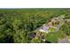 A beautiful aerial view of a well-maintained single Gathering home with a screened-in pool and lush green surroundings at 11598 Sw 74Th Ct, Ocala, FL 34476