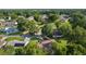 Wide aerial shot displaying the house with solar panels, trees, and neighborhood at 11598 Sw 74Th Ct, Ocala, FL 34476