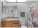 Cozy bathroom featuring a vanity with granite counters, toilet and a shower with novelty themed curtain at 11598 Sw 74Th Ct, Ocala, FL 34476