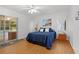 Comfortable bedroom with sliding glass door, ceiling fan and wood flooring at 11598 Sw 74Th Ct, Ocala, FL 34476