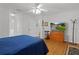 Spacious bedroom with wood floors, neutral decor and ceiling fan at 11598 Sw 74Th Ct, Ocala, FL 34476