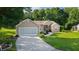 Charming single-story home with a well-manicured lawn and a two-car garage, offering a welcoming curb appeal at 11598 Sw 74Th Ct, Ocala, FL 34476