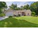 Inviting single-story home featuring a well-maintained lawn, arched windows, and an attached two-car garage at 11598 Sw 74Th Ct, Ocala, FL 34476