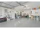 Spacious two car garage with abundant shelving and storage space and sealed concrete floors at 11598 Sw 74Th Ct, Ocala, FL 34476