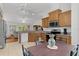 Well-lit kitchen featuring stainless appliances, light wood cabinets, and access to the living room at 11598 Sw 74Th Ct, Ocala, FL 34476