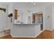 Bright kitchen featuring granite countertops, stainless steel appliances, and breakfast bar seating at 11598 Sw 74Th Ct, Ocala, FL 34476