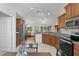 Charming kitchen with wood cabinetry, stainless steel appliances, and a breakfast nook overlooking the backyard at 11598 Sw 74Th Ct, Ocala, FL 34476