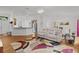 Spacious living room with an open floor plan, comfortable seating, and a view of the adjacent dining area at 11598 Sw 74Th Ct, Ocala, FL 34476