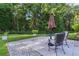 Comfortable patio set sitting on an stone deck with trees adding beauty at 11598 Sw 74Th Ct, Ocala, FL 34476
