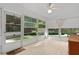 Enclosed porch with white tile flooring, bright airy views, and window treatments at 11598 Sw 74Th Ct, Ocala, FL 34476