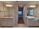 Large bathroom features double sinks, a large mirror, and shower-tub combination at 12384 Sw 96Th Ln, Dunnellon, FL 34432