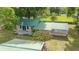 Aerial view of home with a green metal roof, a spacious yard and nearby horse pastures at 1501 Ne 97Th Street Rd, Anthony, FL 32617