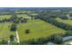 Expansive aerial view of the property with lush pastures and mature trees in a serene setting at 1501 Ne 97Th Street Rd, Anthony, FL 32617