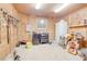 Functional barn tack room featuring wooden walls, storage solutions, and essential equestrian equipment at 1501 Ne 97Th Street Rd, Anthony, FL 32617