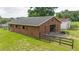 Rustic barn featuring a brown exterior, sliding doors, and ample space for storage or livestock at 1501 Ne 97Th Street Rd, Anthony, FL 32617