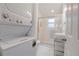 Compact bathroom features a stacked washer/dryer unit and a glass-enclosed walk-in shower at 1501 Ne 97Th Street Rd, Anthony, FL 32617