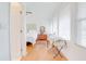 A light-filled bedroom area showcases pristine white walls, hardwood floors, and ample window light at 1501 Ne 97Th Street Rd, Anthony, FL 32617