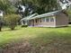 Charming single-story home with a green metal roof and a well-maintained lawn at 1501 Ne 97Th Street Rd, Anthony, FL 32617