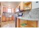 Kitchen with granite countertops, updated appliances, wooden cabinets, and a stainless steel sink at 1501 Ne 97Th Street Rd, Anthony, FL 32617