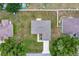 Overhead view of a gray roof home with driveway, bordered by green grass and trees in a neighborhood at 1689 Ne 161St Pl, Citra, FL 32113