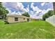 A large, well-maintained backyard with lush green grass and a home featuring a sliding glass door at 1689 Ne 161St Pl, Citra, FL 32113