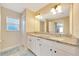 Bathroom featuring double sinks, granite counters, window, and a separate toilet area enhance privacy at 1689 Ne 161St Pl, Citra, FL 32113