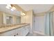Bright bathroom featuring double sinks, granite counters, and walk-in shower create a luxurious space at 1689 Ne 161St Pl, Citra, FL 32113