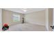Neutral toned bedroom featuring a ceiling fan and a window with a stationary bike at 1689 Ne 161St Pl, Citra, FL 32113