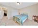 Cozy bedroom featuring a light blue floral bedspread, neutral walls, and a double door closet at 1689 Ne 161St Pl, Citra, FL 32113