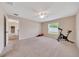 Spacious bedroom with a ceiling fan, window, neutral colored walls, and a partial view into the rest of the house at 1689 Ne 161St Pl, Citra, FL 32113
