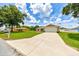 Lovely home featuring a spacious driveway, well-kept lawn, and an attached two-car garage at 1689 Ne 161St Pl, Citra, FL 32113