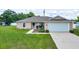 Charming single-story home featuring a well-maintained lawn and attached two-car garage at 1689 Ne 161St Pl, Citra, FL 32113