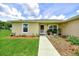 Inviting home exterior with a tidy lawn, landscaped front yard, and close proximity to the front door at 1689 Ne 161St Pl, Citra, FL 32113