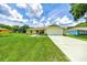 Beautiful home with a lush green lawn, a spacious driveway, and a two-car garage at 1689 Ne 161St Pl, Citra, FL 32113