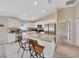 Kitchen with breakfast bar, granite countertops and stainless steel appliances that leads into the living room at 1689 Ne 161St Pl, Citra, FL 32113