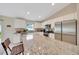 Bright eat-in kitchen with a breakfast bar featuring granite countertops, stainless steel appliances and white cabinetry at 1689 Ne 161St Pl, Citra, FL 32113