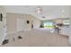 Bright open-concept living area flowing to the kitchen with a sliding glass door to the backyard at 1689 Ne 161St Pl, Citra, FL 32113