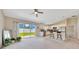 Bright living room with sliding glass doors that lead to a spacious backyard with a partial view into the kitchen at 1689 Ne 161St Pl, Citra, FL 32113