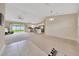 Spacious open-concept living room with natural light and seamless transition to kitchen with bar seating at 1689 Ne 161St Pl, Citra, FL 32113