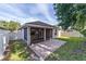 This backyard boasts a screened-in patio, brick pavers, and fencing offering a perfect blend of privacy and relaxation at 2127 Ne 38Th Ter, Ocala, FL 34470